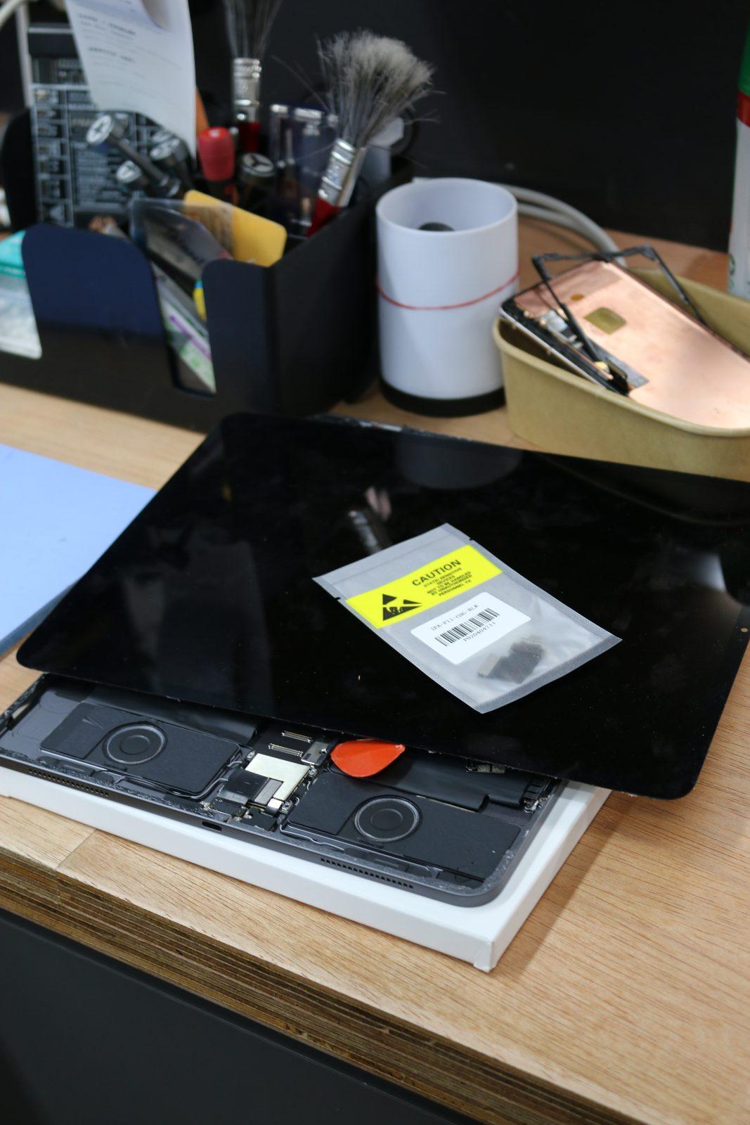Hands-on device repair content shot for a client